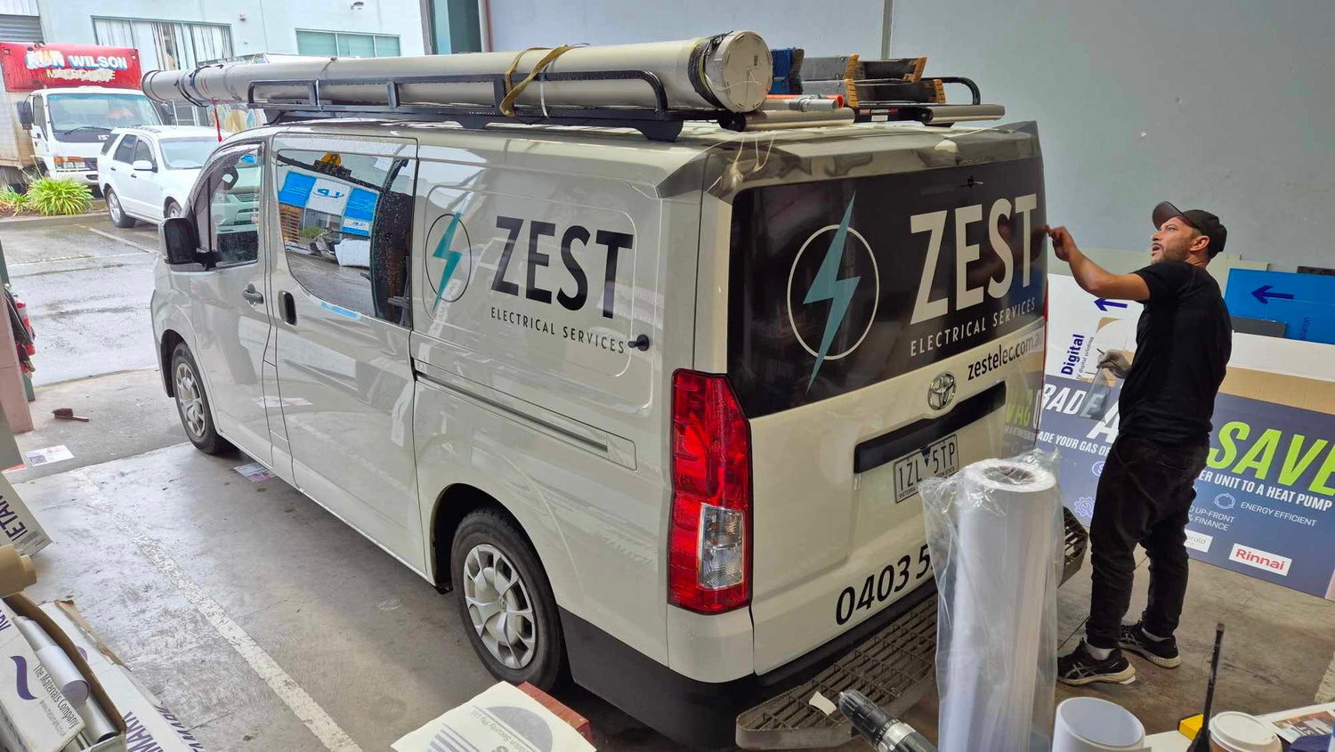 Van with ZEST Electrical Services branding in a parking lot.