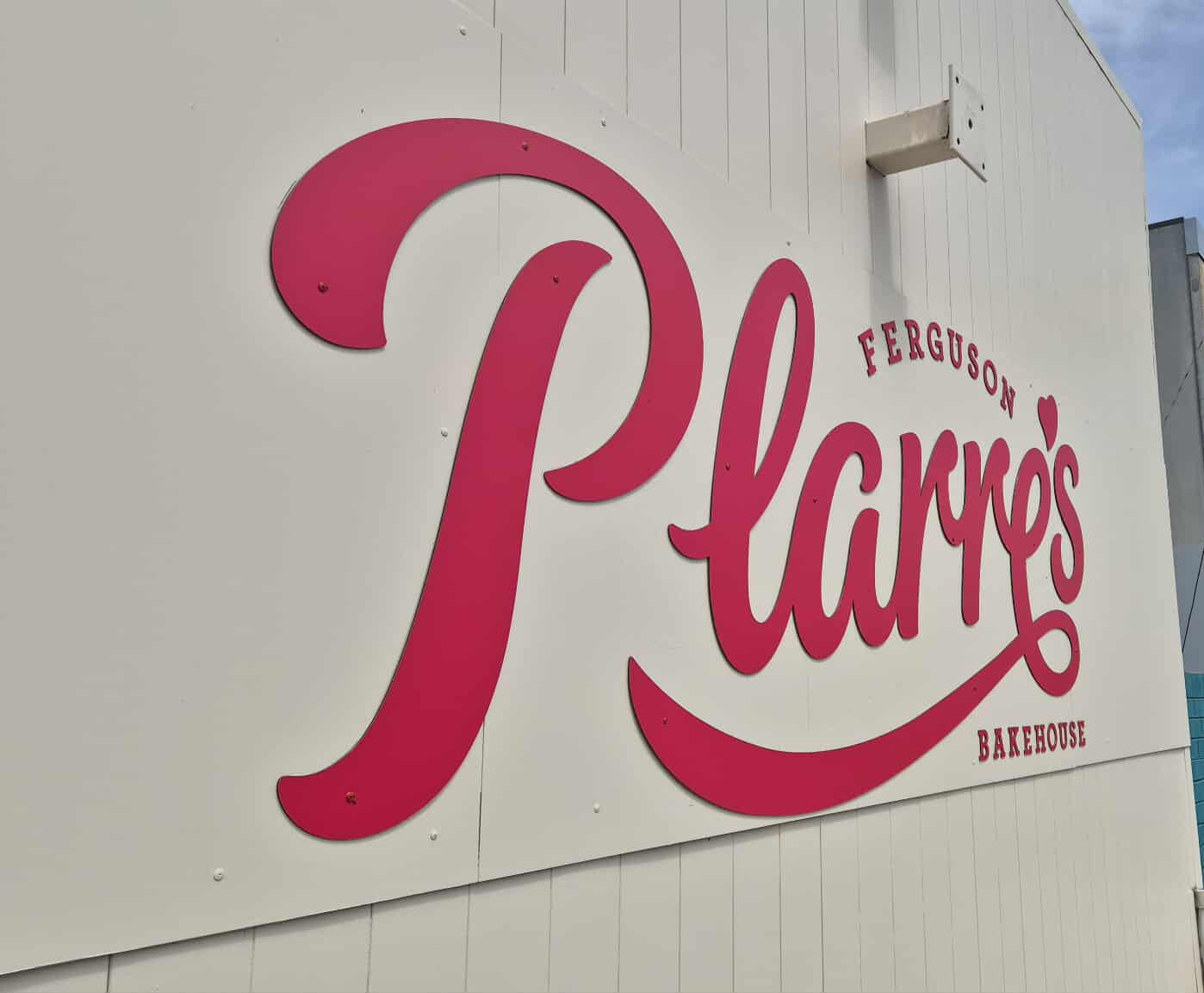 Platter's restaurant sign on a building with 'The Shopping Place' sign in the background.