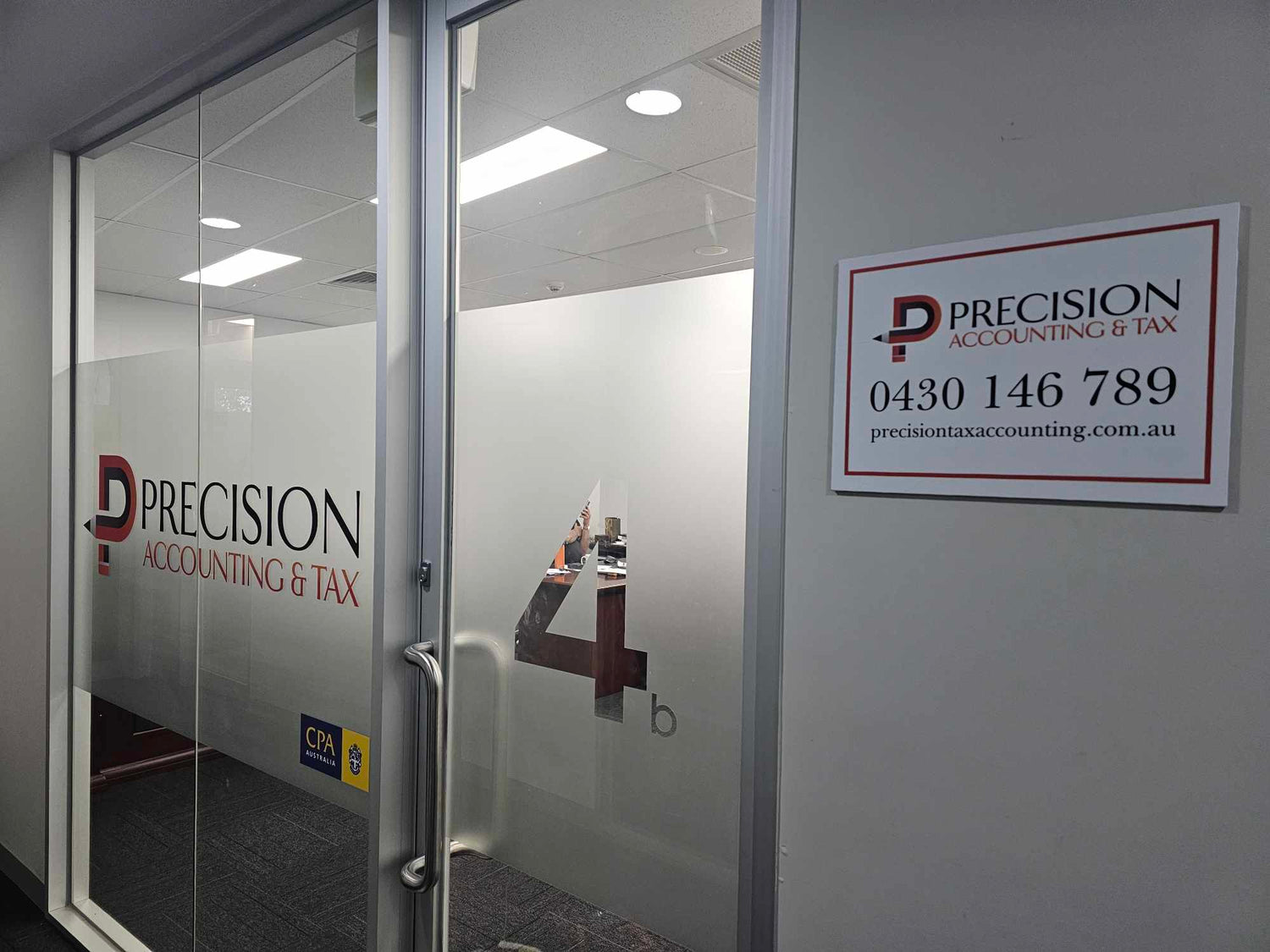 Glass door with 'Precision Accounting & Tax' branding and contact information.