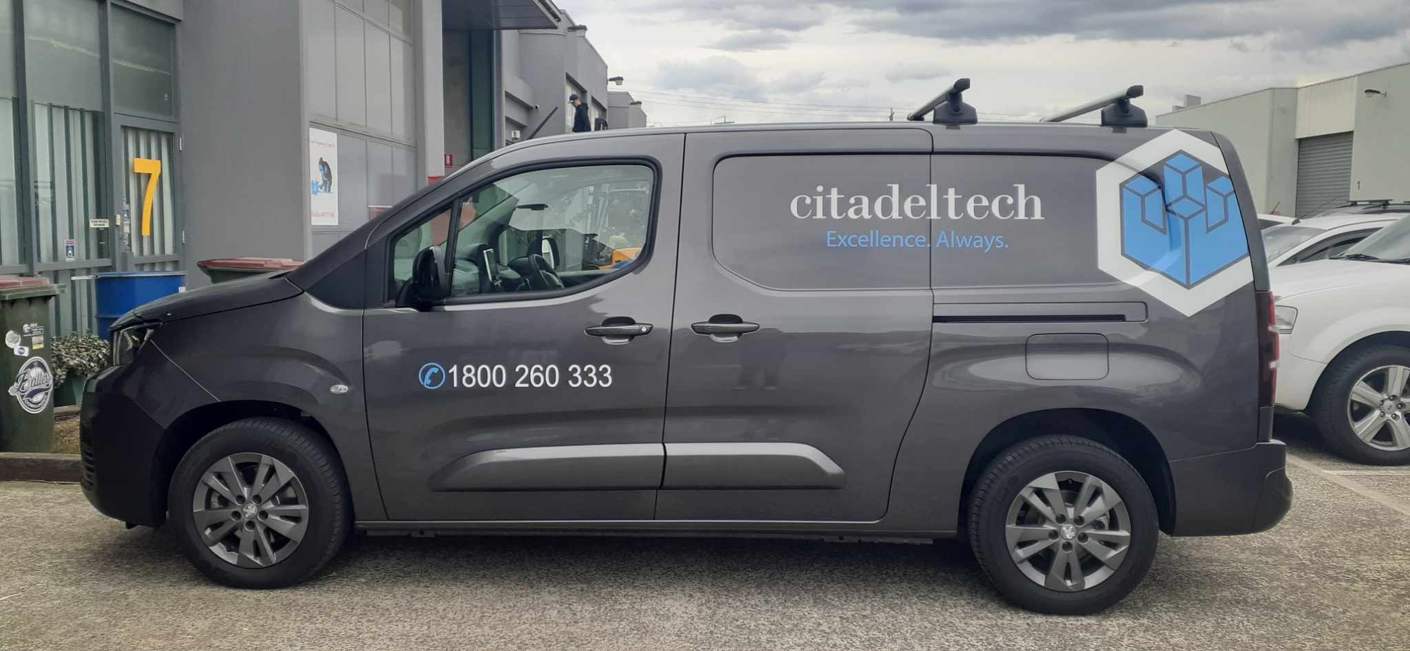 Gray van with Citadeltech branding and contact information on a parking lot.