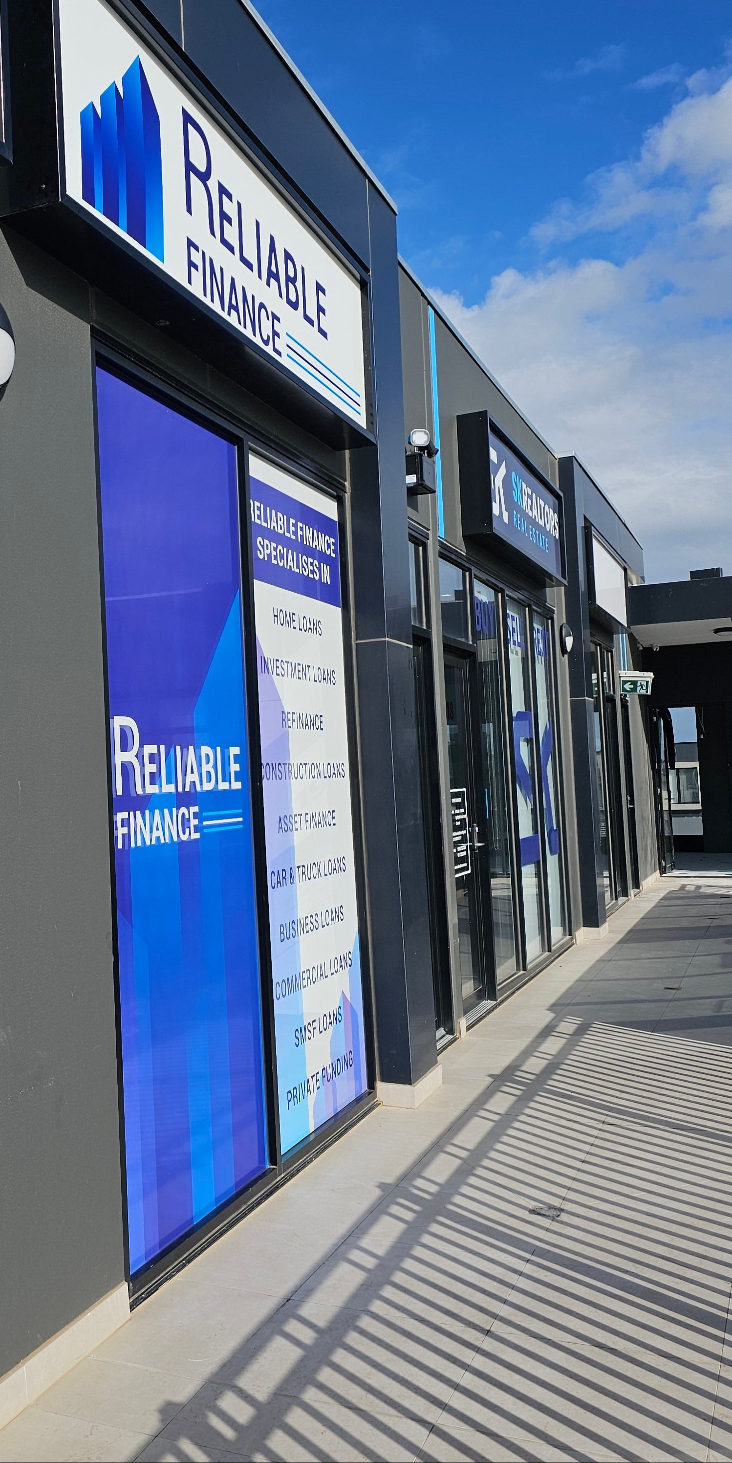 Building facade with 'Reliable Finance' signs and branding