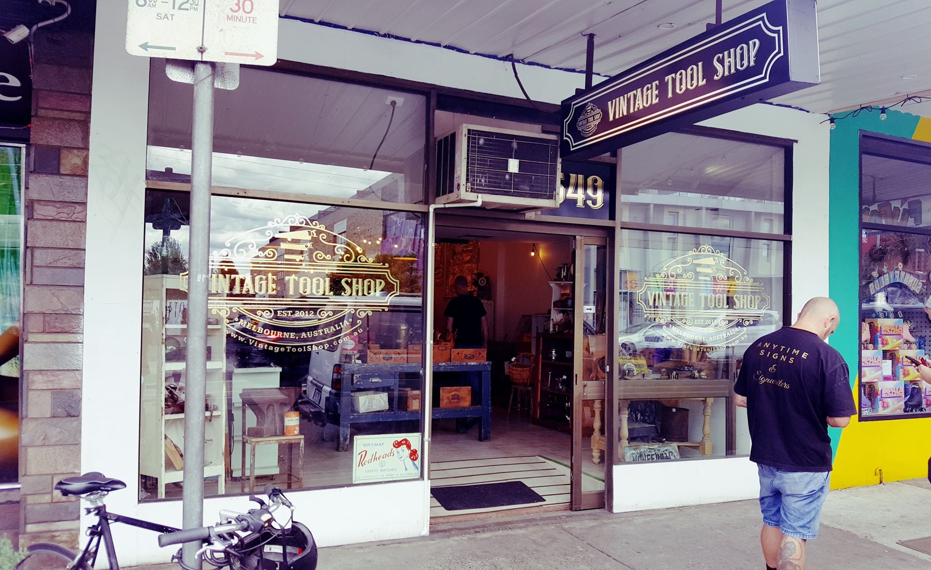 Vintage Tool Shop with people outside, bike parked on sidewalk